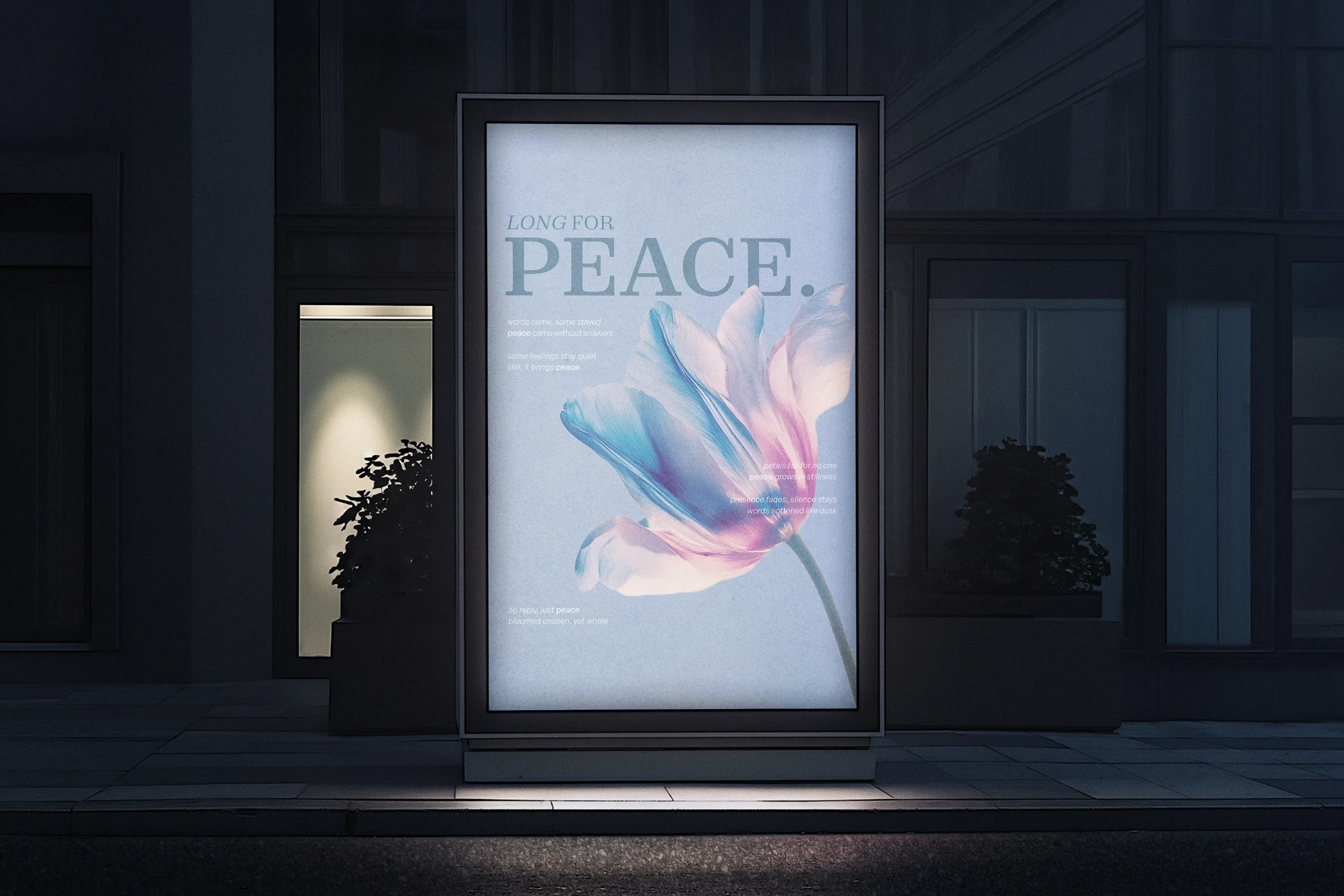 Long For Peace glowing as a lightbox at night, a blue bloom against pale type.